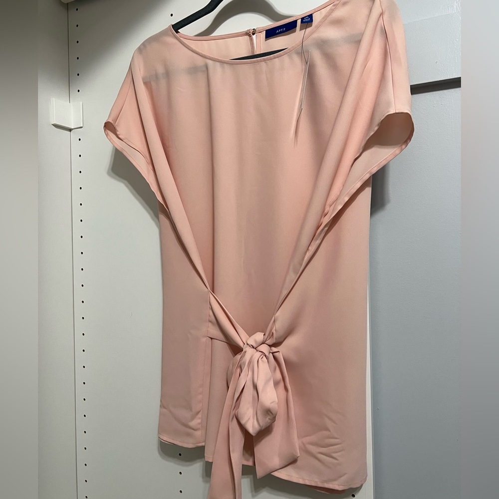 Brand new with tags. 100% polyester,  very light weight pink blouse